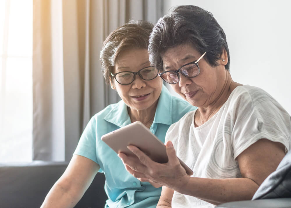 sisters looking at tablet