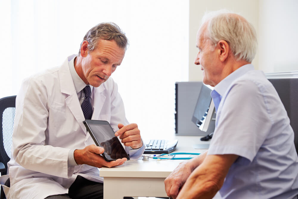 doctor showing patient tablet