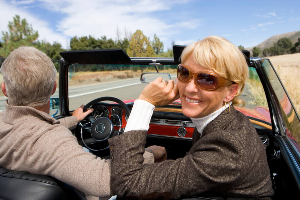 woman in sunglasses in convertable